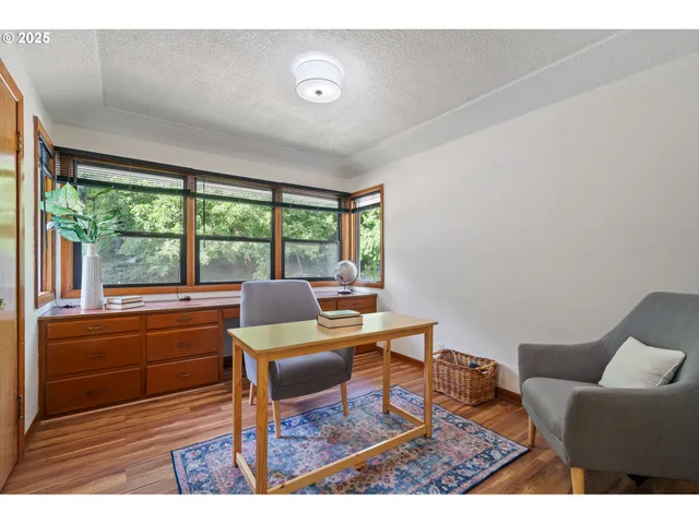 a bathroom with a sink a mirror and a potted plant
