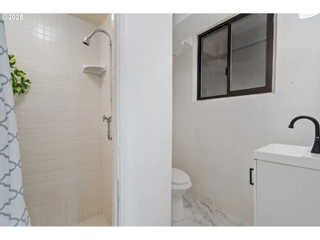 a view of a patio with plants and chairs