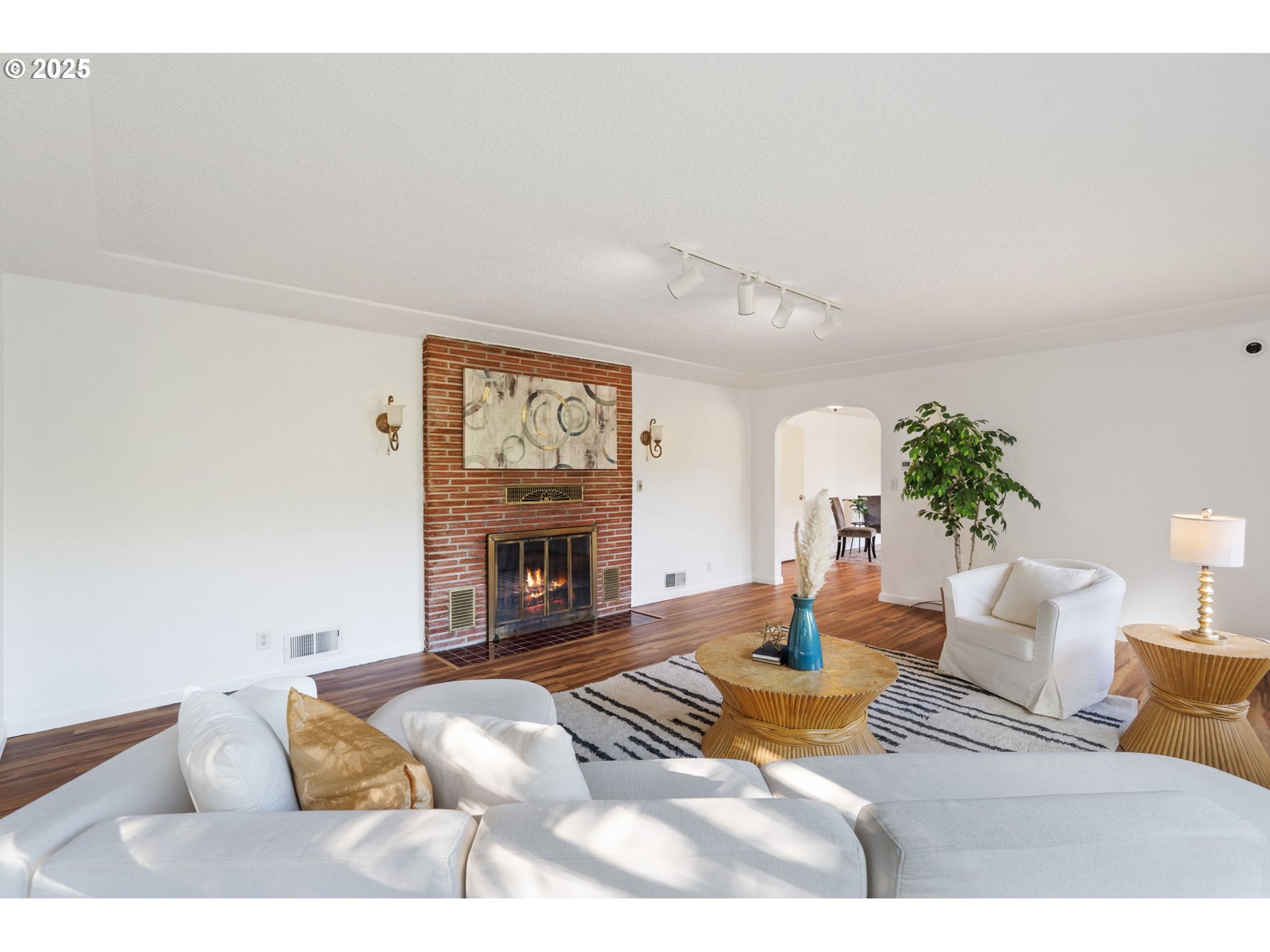 402 Skelton Road Stevenson, WA 98648 - Photo 8 of 48 a living room with furniture a fireplace and a potted plant