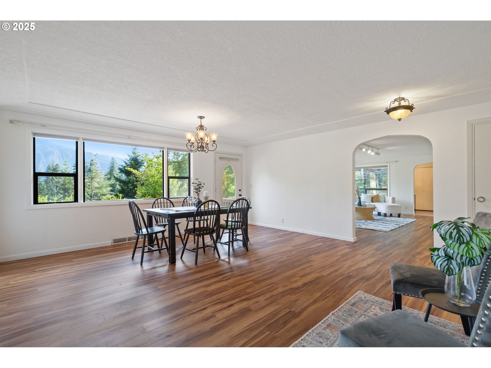 402 Skelton Road Stevenson, WA 98648 - Photo 9 of 48 a view of a dining room with furniture and wooden floor