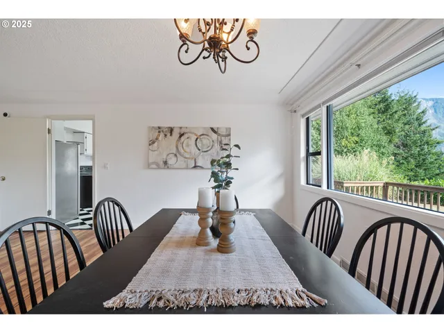 a view of a dining room with furniture window and outside view