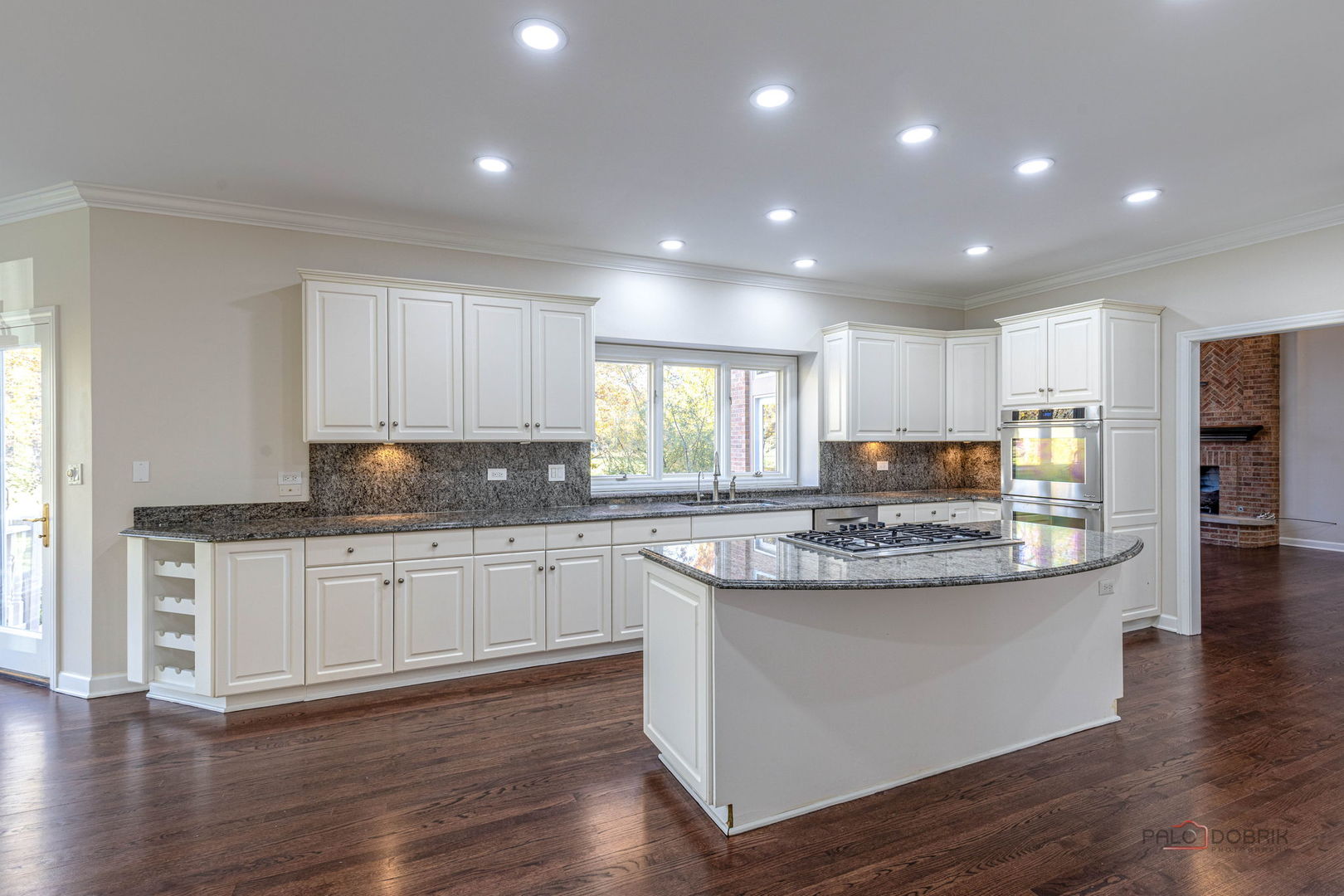 12 Riderwood Road North Barrington, IL 60010 - Photo 16 of 44 a kitchen with stainless steel appliances granite countertop wooden floor and window