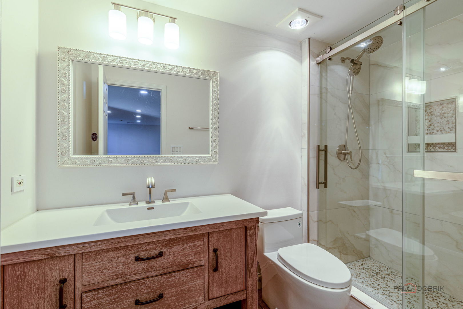 12 Riderwood Road North Barrington, IL 60010 - Photo 36 of 44 a bathroom with a shower sink vanity mirror and toilet
