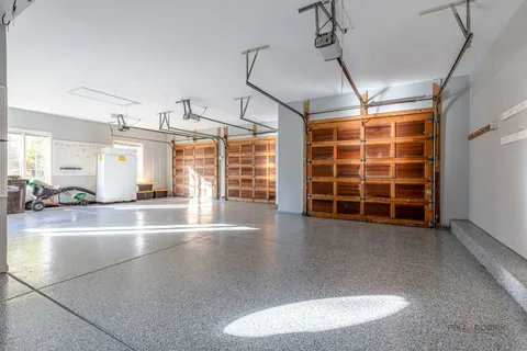 a view of empty room with wooden floor and windows