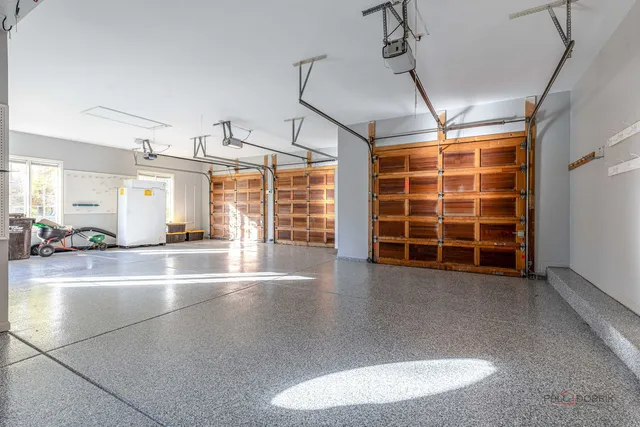 a view of empty room with wooden floor and windows