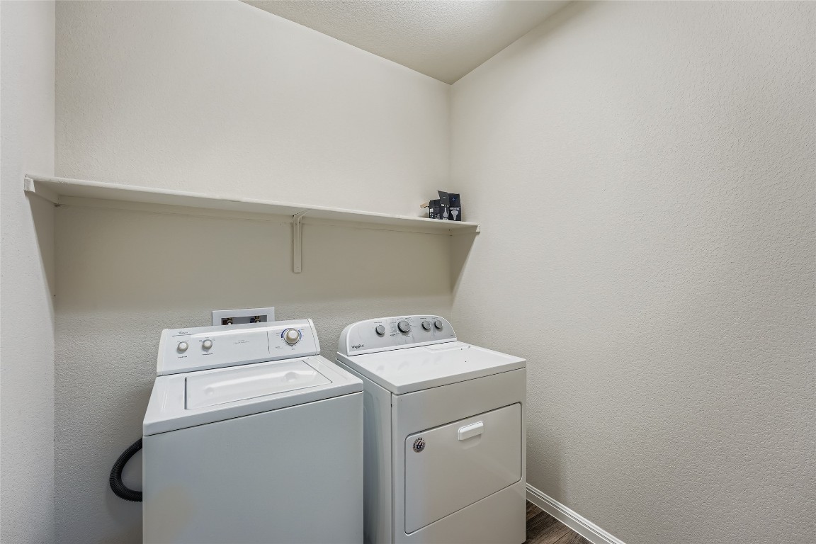 14601 Frankel Loop Pflugerville, TX 78660 - Photo 11 of 17 Laundry room featuring a washer and dryer, and dark wood-type flooring