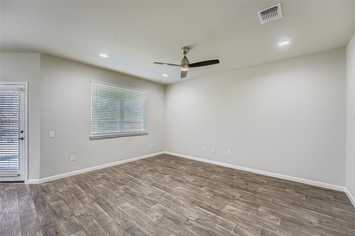 14601 Frankel Loop Pflugerville, TX 78660 - Photo 2 of 17 Spare room with dark wood-style floors, recessed lighting, and a ceiling fan