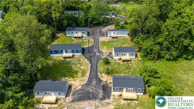 an aerial view of a house with yard swimming pool and outdoor seating