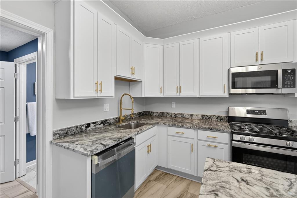 1331 Pritchard Street Pittsburgh, PA 15204 - Photo 16 of 49 a kitchen with granite countertop a stove and a sink