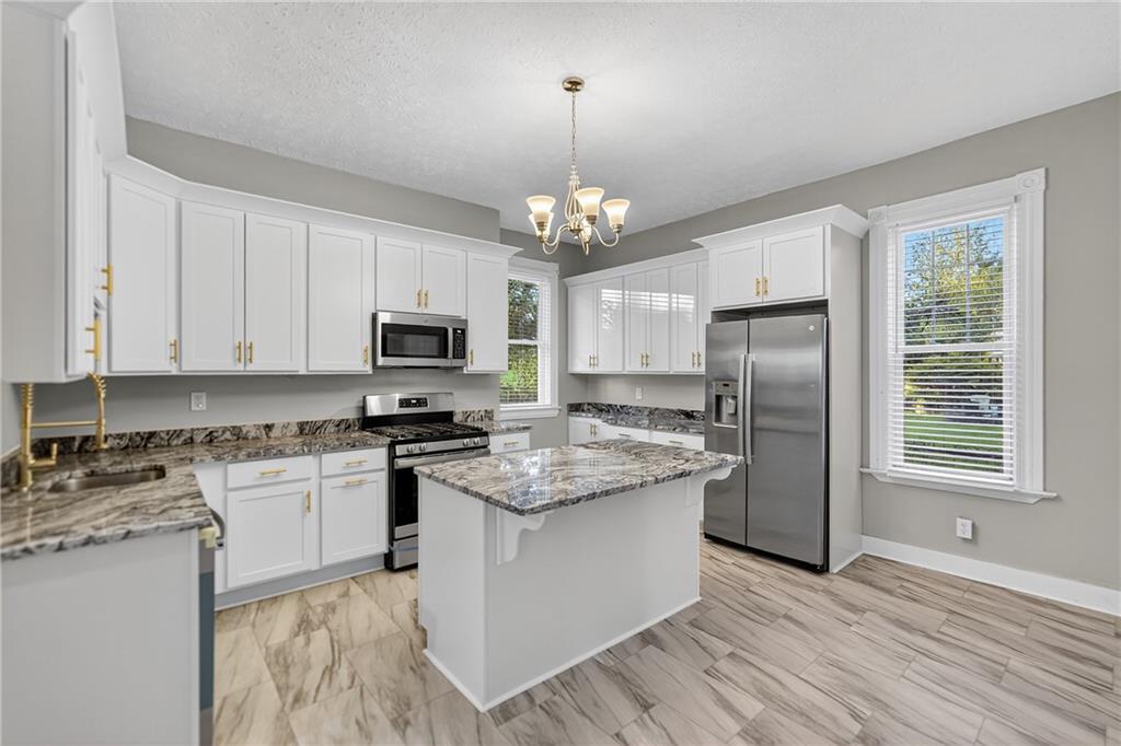 1331 Pritchard Street Pittsburgh, PA 15204 - Photo 18 of 49 a kitchen with stainless steel appliances granite countertop a stove top oven a refrigerator a sink and dishwasher with wooden floor