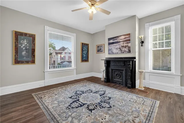 a view of an empty room with window and wooden floor