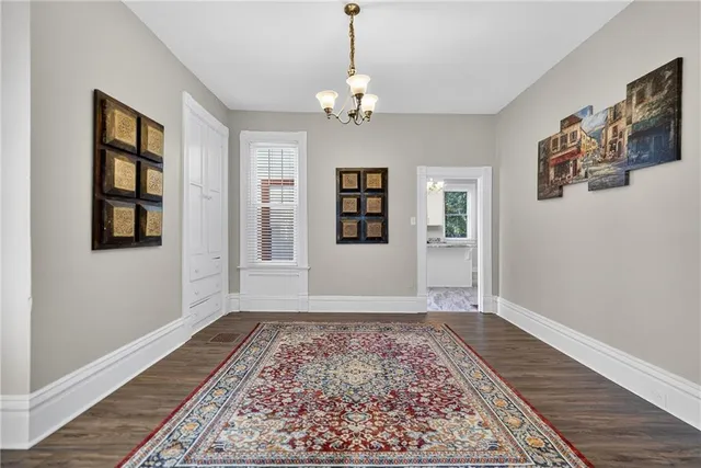 a view of a livingroom with wooden floor and a window