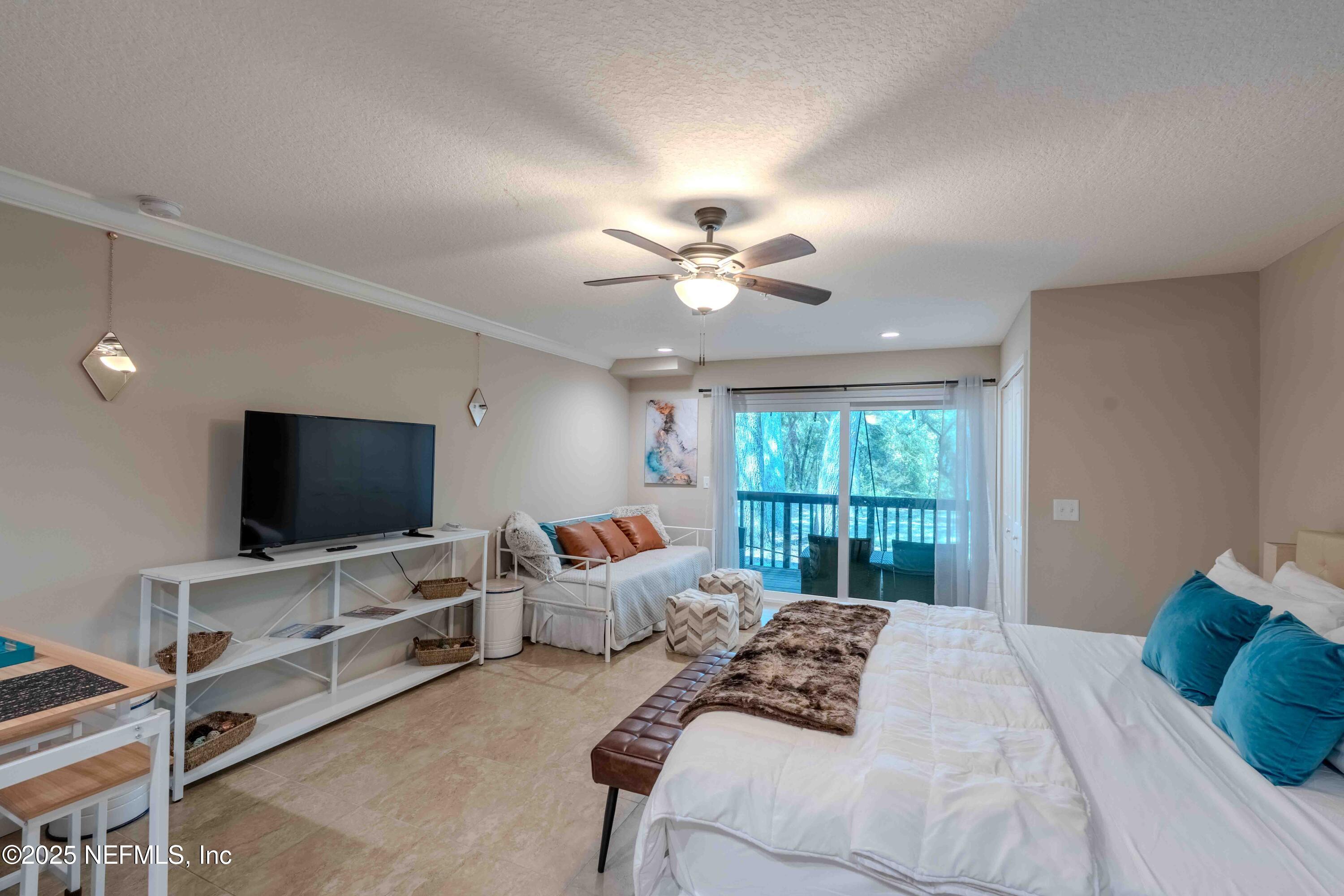 3145 Ravines Road Middleburg, FL 32068 - Photo 16 of 26 a bedroom with bed tv and window