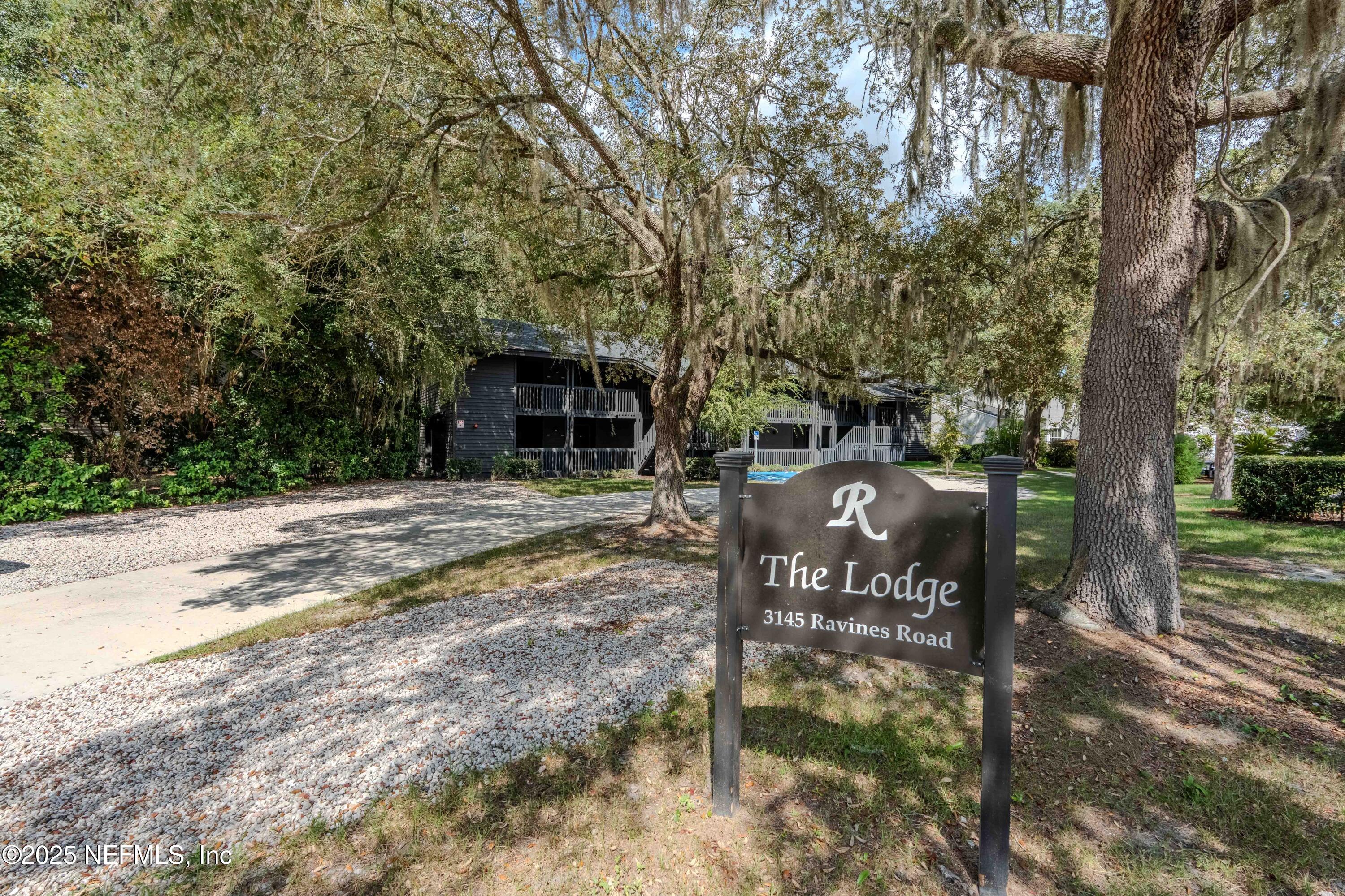 3145 Ravines Road Middleburg, FL 32068 - Photo 4 of 26 a wooden bench sitting in front of a tree