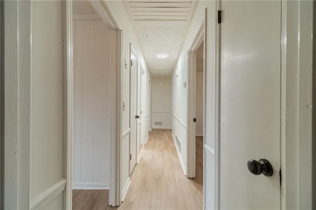 a view of a hallway with wooden floor