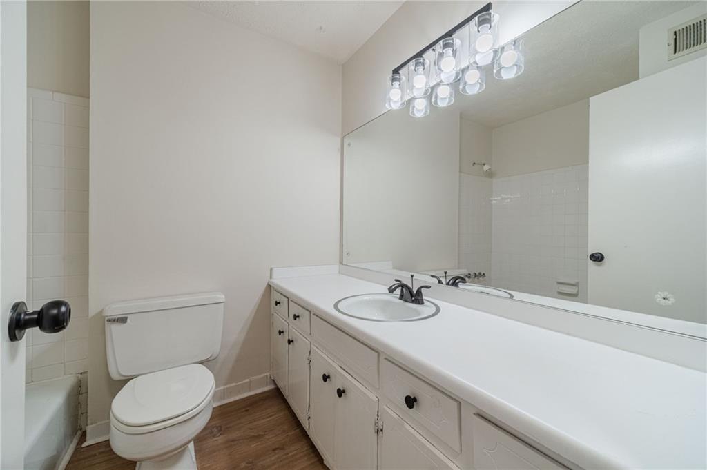 1678 Pounds Road Southwest Stone Mountain, GA 30087 - Photo 17 of 25 a bathroom with a sink a toilet and shower