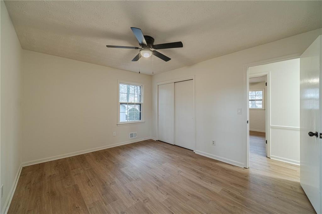 1678 Pounds Road Southwest Stone Mountain, GA 30087 - Photo 19 of 25 a view of empty room with wooden floor and fan