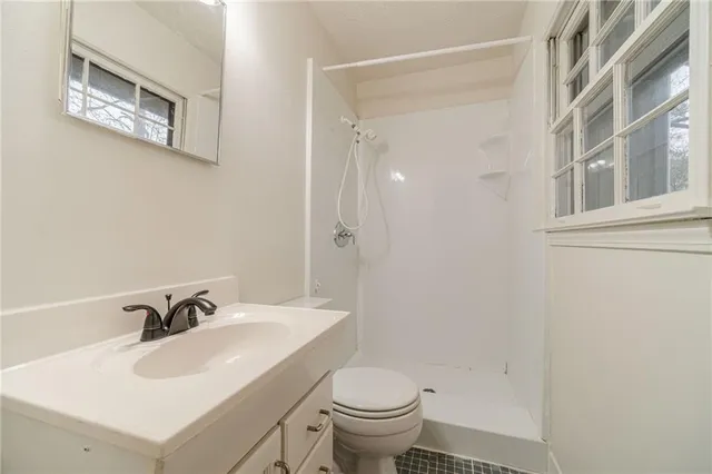 a bathroom with a sink toilet and a mirror