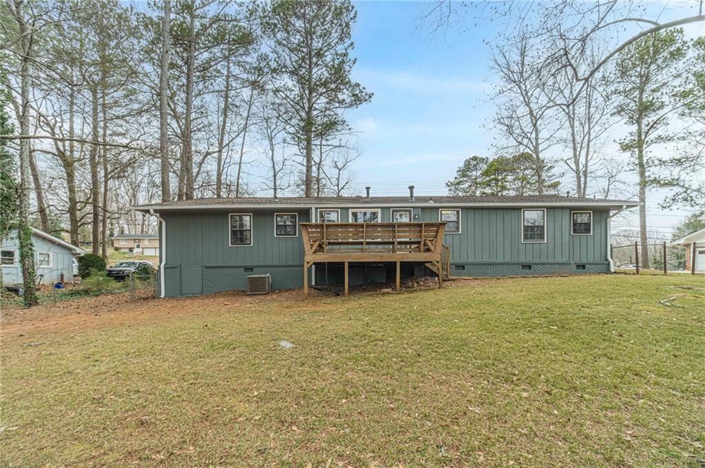 1678 Pounds Road Southwest Stone Mountain, GA 30087 - Photo 25 of 25 a view of a house with a yard and garage