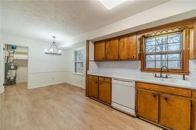 a kitchen with a sink stove and cabinets
