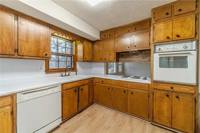 a kitchen with stainless steel appliances granite countertop a sink and cabinets