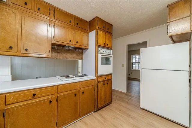 a kitchen with stainless steel appliances a refrigerator and a stove