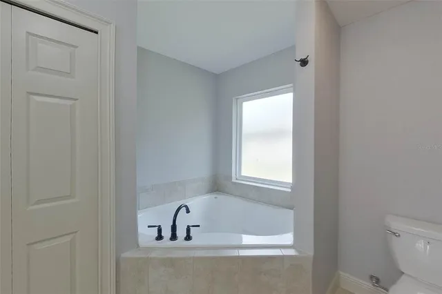 a bathroom with a bathtub and a toilet