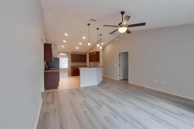 a view of kitchen with refrigerator microwave and stove