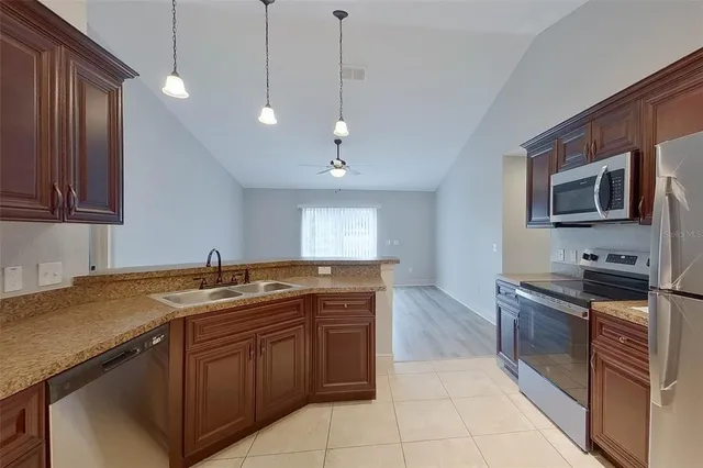 a kitchen with a sink stove and microwave