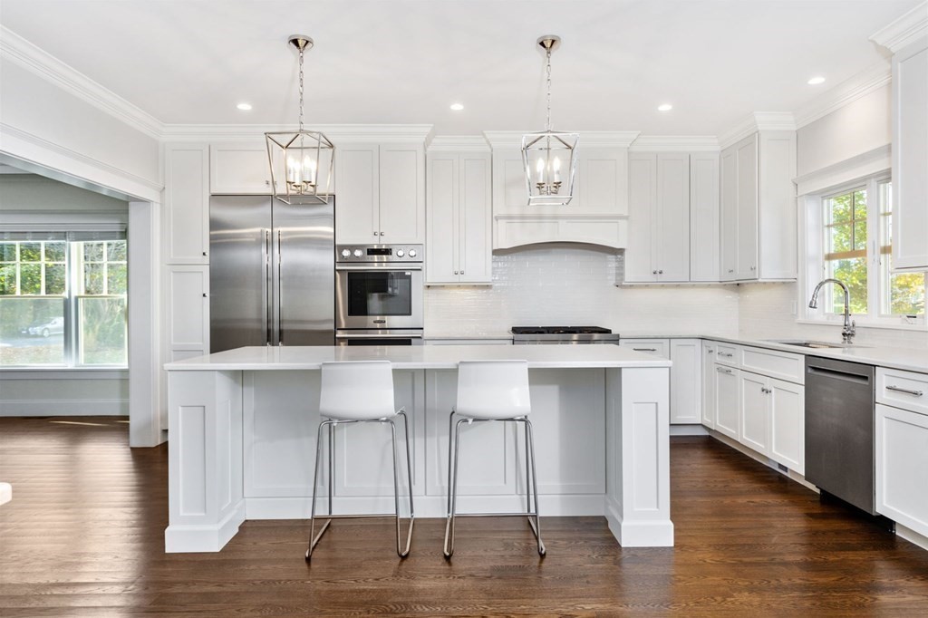 19 Turner Road Wellesley, MA 02482 - Photo 2 of 23 a kitchen with kitchen island granite countertop a sink cabinets and wooden floor