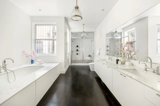 a large white kitchen with a large window