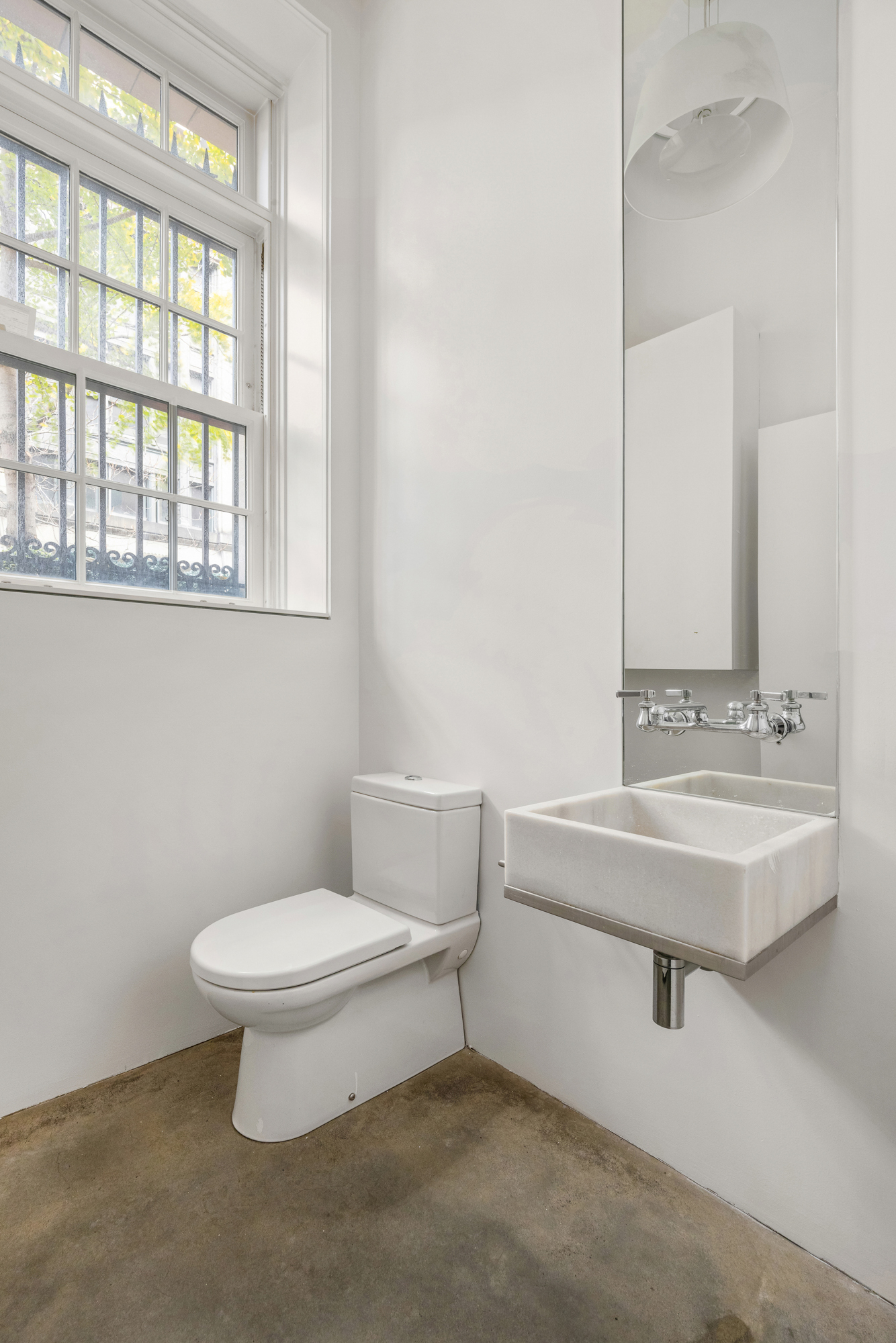 178 East 73rd Street Manhattan, NY 10021 - Photo 14 of 16 a bathroom with a sink a toilet and a mirror