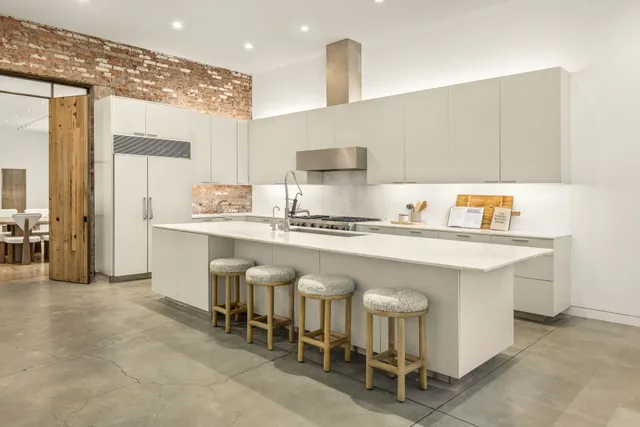 a living room with furniture large window and a table