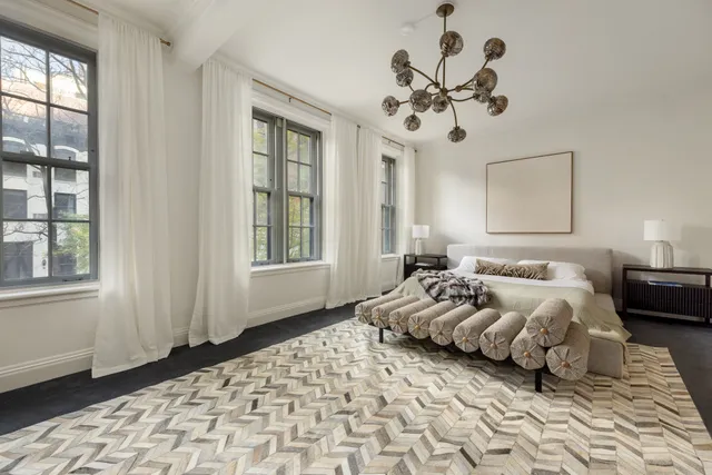 a bedroom with bed and window