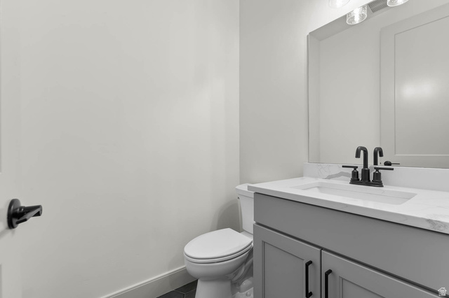 562 West Coyote Rdg Road Grantsville, UT 84029 - Photo 18 of 27 Modern bathroom featuring a single vanity with a light gray cabinet, white countertop, and matte black faucet