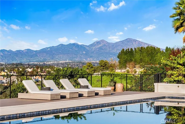 a view of a terrace with a bench and mountain view