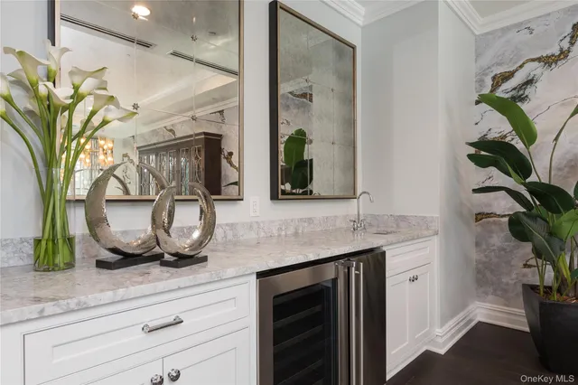 a bathroom with a granite countertop sink a potted plant and a mirror