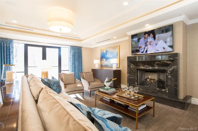 a living room with furniture a fireplace and a flat screen tv