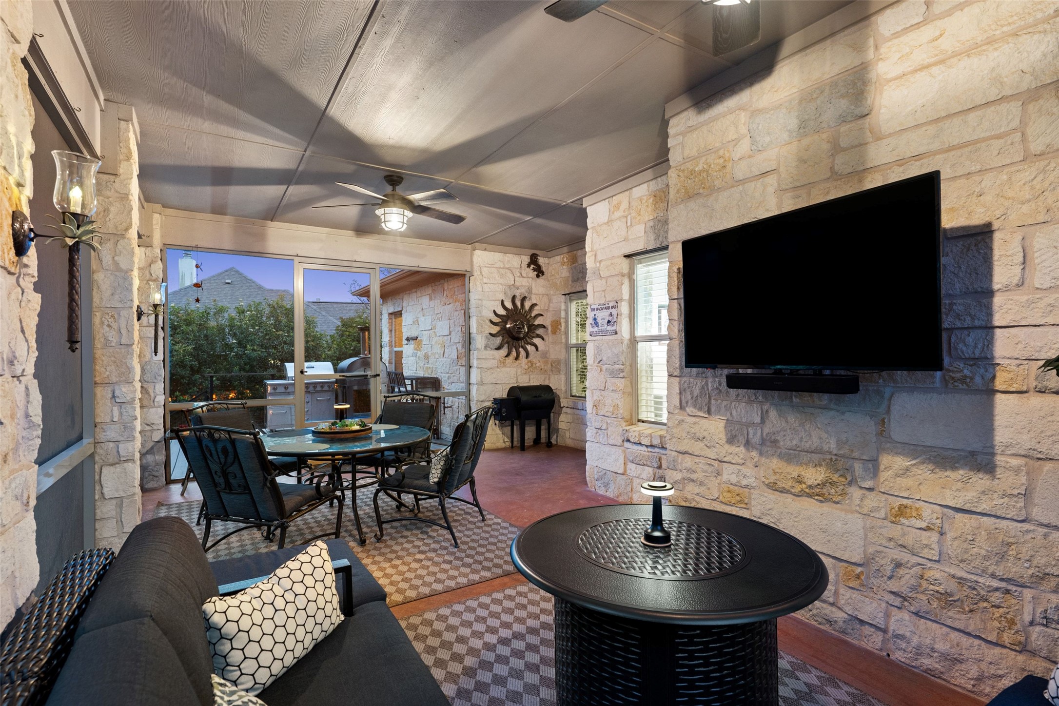 15208 Nightingale Lane Austin, TX 78734 - Photo 4 of 40 Cozy covered patio space perfect for relaxing and watching your favorite show during any season set close to the bbq deck area, grotto style pool w/ water feature, and park like backyard setting.