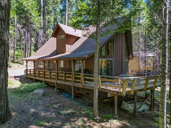a front view of a house with a yard table and chairs