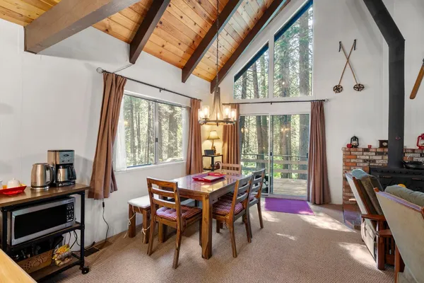 a dining room with furniture water view and a fireplace