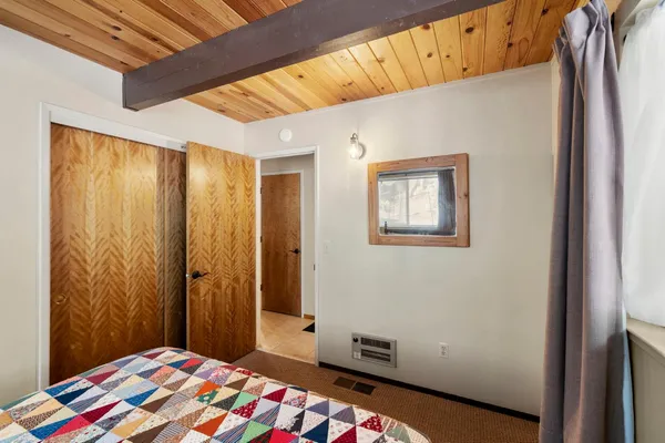 a bedroom with a bed and a lamp