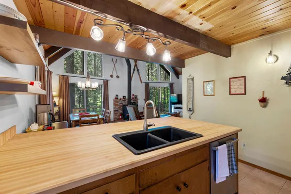 a kitchen with stainless steel appliances a sink a table and chairs