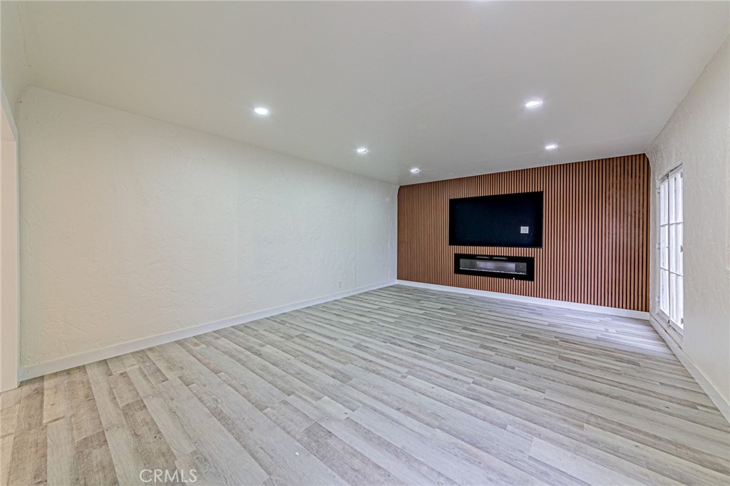 5355 West 8th Street Los Angeles, CA 90036 - Photo 16 of 32 a view of room with wooden floor and flat screen tv