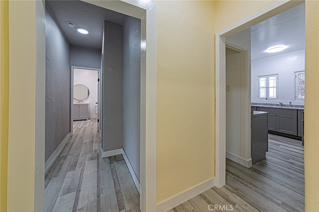 5355 West 8th Street Los Angeles, CA 90036 - Photo 19 of 32 a view of a hallway with wooden floor and a bathroom