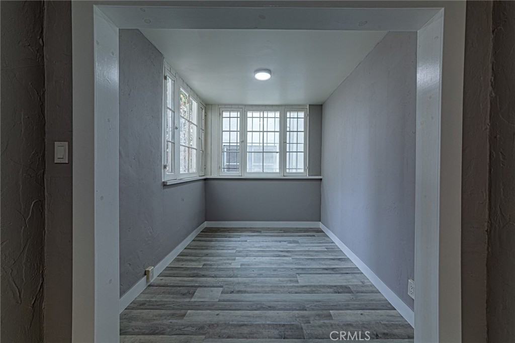 5355 West 8th Street Los Angeles, CA 90036 - Photo 23 of 32 a view of an empty room with wooden floor and a window