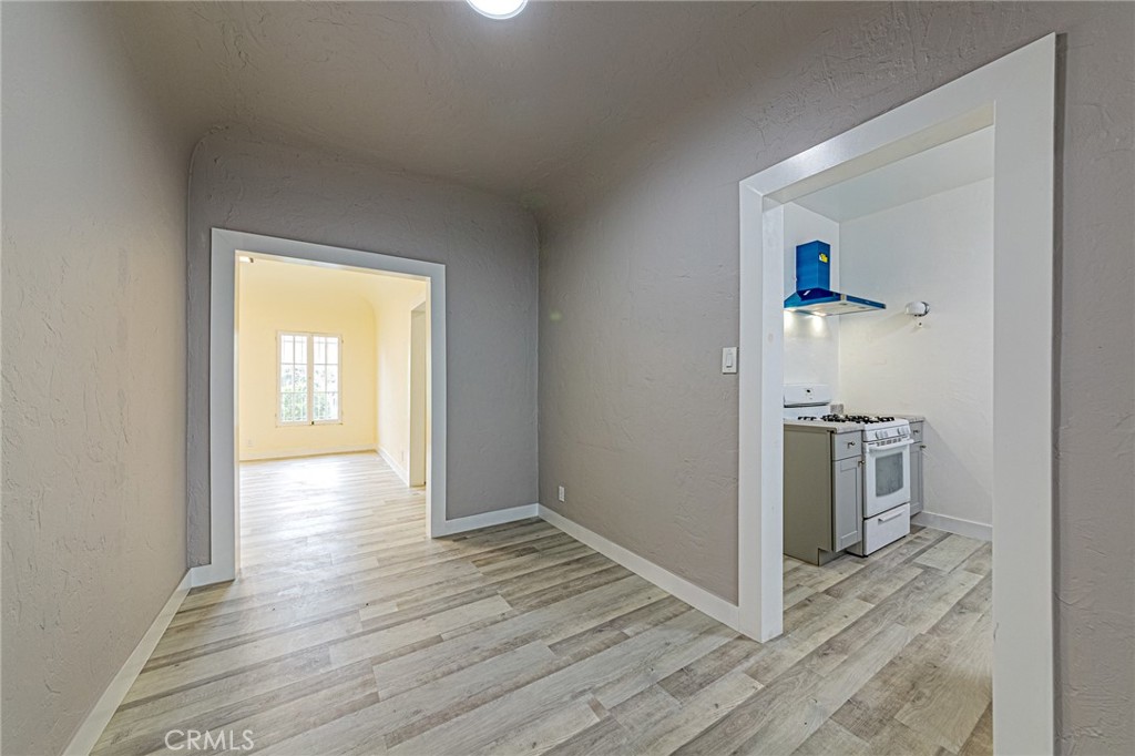 5355 West 8th Street Los Angeles, CA 90036 - Photo 24 of 32 a view of a kitchen from an empty room and wooden floor