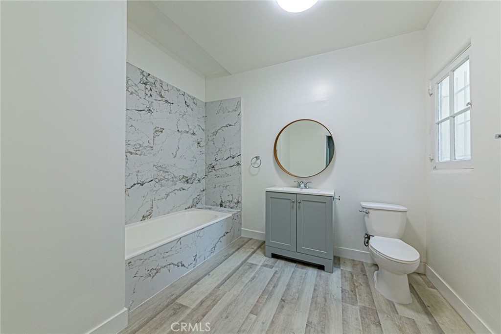 5355 West 8th Street Los Angeles, CA 90036 - Photo 30 of 32 a bathroom with a sink a toilet and a bathtub