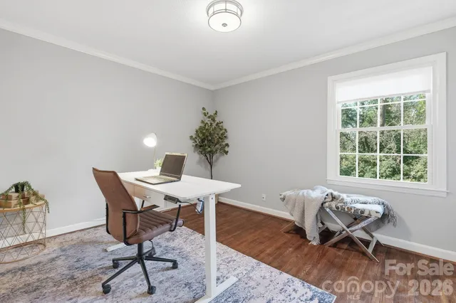 a workspace with furniture window and wooden floor