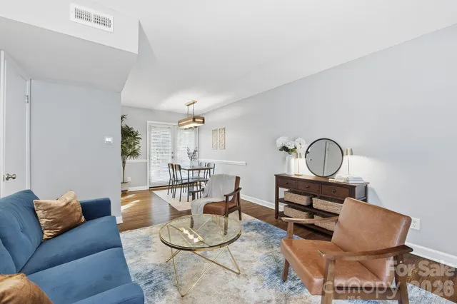 a living room with furniture a couch and wooden floor